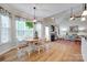 Bright dining area features a light wood table, four chairs, bay window, and an ornate light fixture at 2050 Sunswept Ln, York, SC 29745