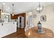 Bright dining area featuring modern lighting, a wood table, and an open connection to the kitchen at 2050 Sunswept Ln, York, SC 29745