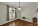 Bright dining room featuring hardwood floors, a hanging light fixture, and a large window at 2050 Sunswept Ln, York, SC 29745