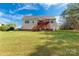 Back exterior view of house with large backyard, deck and stairs, surrounded by well-maintained grass at 2050 Sunswept Ln, York, SC 29745