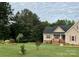 Beautiful home with lush landscaping, red shutters, and a cozy covered front porch at 2050 Sunswept Ln, York, SC 29745