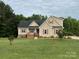 Charming two-story home with red shutters, brick accents, covered porch, and well-manicured lawn at 2050 Sunswept Ln, York, SC 29745