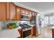 Close-up of the kitchen shows stainless steel appliances, custom cabinetry, and a tiled backsplash at 2050 Sunswept Ln, York, SC 29745