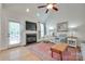 Bright living room featuring a fireplace with a wall-mounted TV, hardwood floors, and a comfortable seating area at 2050 Sunswept Ln, York, SC 29745