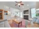Bright living room with a fireplace, modern ceiling fan, open to the dining and kitchen areas, and hardwood flooring at 2050 Sunswept Ln, York, SC 29745