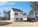 Exterior view of a new white two-story home with modern windows and backyard at 2125 Tom Sadler Rd # 7159, Charlotte, NC 28214