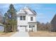 Charming two-story home with a white exterior, a welcoming entryway, and a convenient attached garage at 2125 Tom Sadler Rd # 7159, Charlotte, NC 28214