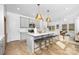 Open-concept kitchen with island seating, stainless steel appliances, and seamless flow to the living area at 2125 Tom Sadler Rd # 7159, Charlotte, NC 28214