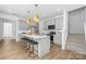 Modern kitchen with a spacious island, seating, stainless appliances, and a seamless connection to the staircase at 2125 Tom Sadler Rd # 7159, Charlotte, NC 28214