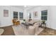 Bright, open living room with neutral tones, stylish decor, and plenty of natural light from large windows at 2125 Tom Sadler Rd # 7159, Charlotte, NC 28214