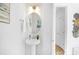 This powder room features a pedestal sink, an oval mirror, and classic decor at 2125 Tom Sadler Rd # 7159, Charlotte, NC 28214