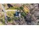 Aerial view of a house with a long driveway and lush lawn, highlighting privacy and curb appeal at 227 Spicewood Cir, Troutman, NC 28166