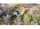 Aerial view of a house with a long driveway, lush lawn, and bordered by mature trees at 227 Spicewood Cir, Troutman, NC 28166