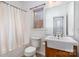 Bathroom with white fixtures and a farmhouse sink design, enhanced by natural light from a window at 227 Spicewood Cir, Troutman, NC 28166