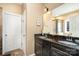 Bathroom with dual sink vanity, granite countertops, and tile floors, showcasing modern elegance at 227 Spicewood Cir, Troutman, NC 28166