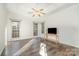 Airy bedroom with tray ceiling, ceiling fan, hardwood floors, and plenty of natural light from three large windows at 227 Spicewood Cir, Troutman, NC 28166