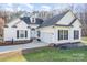 Charming two-story home with white siding, black shutters, attached two car garage and inviting curb appeal at 227 Spicewood Cir, Troutman, NC 28166