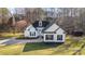 Charming two-story home with white siding, black shutters, well manicured lawn and inviting curb appeal at 227 Spicewood Cir, Troutman, NC 28166
