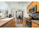 Functional kitchen with stainless steel appliances, tile countertops, ample wood cabinet space, and open dining area at 227 Spicewood Cir, Troutman, NC 28166
