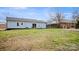 Expansive backyard featuring a charming light blue house with a sliding glass door and ample space for outdoor activities at 2509 Lanecrest Dr, Charlotte, NC 28215