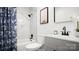 Elegant bathroom featuring a shower over bath, marble tile, and refined vanity at 2509 Lanecrest Dr, Charlotte, NC 28215