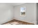 Minimalist bedroom with hardwood floors and a large window for ample sunlight at 2509 Lanecrest Dr, Charlotte, NC 28215