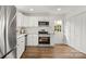 Modern kitchen featuring stainless steel appliances, white cabinets, granite countertops and hardwood floors at 2509 Lanecrest Dr, Charlotte, NC 28215