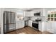 Modern kitchen featuring stainless steel appliances, white cabinets, granite countertops and hardwood floors at 2509 Lanecrest Dr, Charlotte, NC 28215