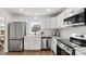 Modern kitchen with white cabinetry, stainless steel appliances, and a window view at 2509 Lanecrest Dr, Charlotte, NC 28215