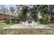 Concrete patio in a backyard with a seating arrangement, landscaping, and a modern privacy screen at 2509 Lanecrest Dr, Charlotte, NC 28215