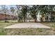 Concrete patio surrounded by a chain link fence and trees in a backyard setting at 2509 Lanecrest Dr, Charlotte, NC 28215