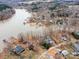Overhead view of homes in a wooded, lakefront community with docks, and small beach on a grey day at 265 Sailboat Dr, Salisbury, NC 28146