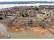 An aerial view showcasing waterfront homes with private docks, nestled along a lake surrounded by trees at 265 Sailboat Dr, Salisbury, NC 28146