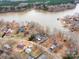 An aerial view of waterfront homes on a lake, featuring private docks and tree lined streets at 265 Sailboat Dr, Salisbury, NC 28146