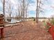 Spacious backyard featuring a storage shed, mature trees, and lake access, ideal for outdoor activities at 265 Sailboat Dr, Salisbury, NC 28146