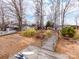 Backyard featuring a wooden dock, lush greenery, and direct access to the lake, ideal for water enthusiasts at 265 Sailboat Dr, Salisbury, NC 28146