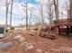View of the backyard with mature trees and a wooden deck, perfect for outdoor enjoyment at 265 Sailboat Dr, Salisbury, NC 28146
