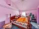 Pink bedroom features a patterned bedspread, patterned wallpaper, bright natural light, and sloped ceiling at 265 Sailboat Dr, Salisbury, NC 28146