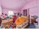 Bedroom features pink walls, carpeted floor, bright natural light, a closet, and sloped ceiling at 265 Sailboat Dr, Salisbury, NC 28146