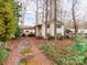A two story home with a car port is nestled among the trees in this quiet wooded setting at 265 Sailboat Dr, Salisbury, NC 28146