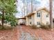 A two-story home with an attached carport and a lush green tree in the foreground, offering a tranquil setting at 265 Sailboat Dr, Salisbury, NC 28146