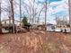 Exterior view of the home with a deck, storage shed, and lake access, perfect for outdoor living at 265 Sailboat Dr, Salisbury, NC 28146