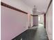 Hallway with pink walls and dated carpet features a vaulted ceiling and access to other rooms at 265 Sailboat Dr, Salisbury, NC 28146