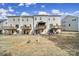 A view of the rear of the townhomes, each featuring a private wooden deck, and a shared grassy backyard at 2656 Grantham Place Dr, Fort Mill, SC 29715