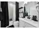 Well-lit bathroom featuring modern fixtures, dark accents, and a shower-tub combination with a stylish shower curtain at 2656 Grantham Place Dr, Fort Mill, SC 29715