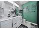 Bright bathroom with double vanity, white cabinets, black hardware, and trendy artwork on the accent wall at 2656 Grantham Place Dr, Fort Mill, SC 29715