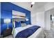 A bedroom featuring a decorative blue accent wall, plush carpet, and elegant bedding for a serene retreat at 2656 Grantham Place Dr, Fort Mill, SC 29715