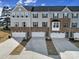New construction townhomes feature brick accents, gray siding, and white garage doors at 2656 Grantham Place Dr, Fort Mill, SC 29715