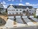 A drone shot features the townhome's facade, highlighting the garage and driveway at 2656 Grantham Place Dr, Fort Mill, SC 29715