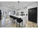 Bright kitchen with large island, modern pendant lighting, and stainless steel appliances at 2656 Grantham Place Dr, Fort Mill, SC 29715